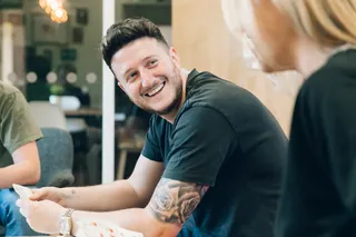 Andy Golpys smiling whilst playing cards with the team